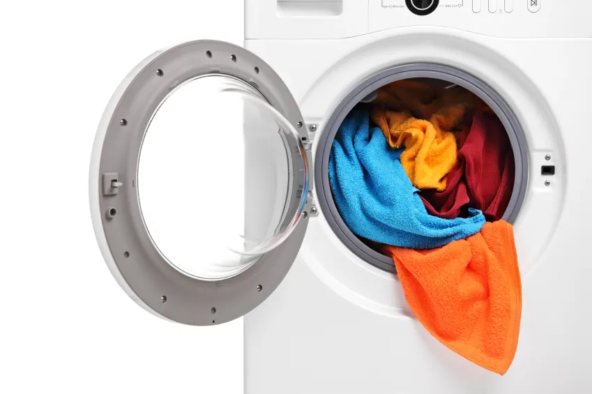 Washing machine with door open and colored towels inside