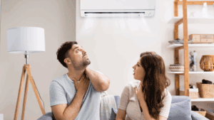 %Title% | Aaa Service Network AAA Service Network customers relax on a couch, enjoying cool air from their newly installed air conditioner above.
