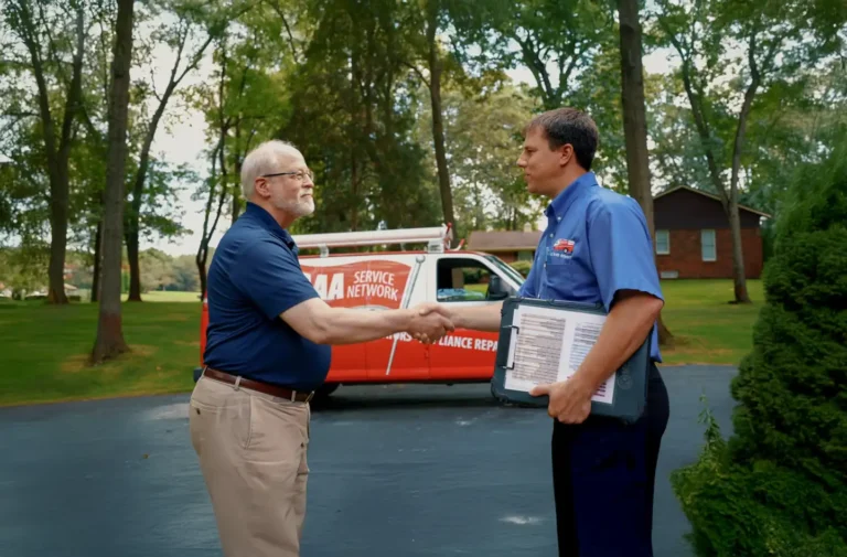 A AAA Service Network team member greets a new hire in a driveway, red service van behind them, highlighting career opportunities.
